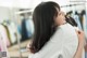 A woman hugging another woman in a clothing store.