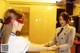 A woman in a business suit shaking hands with another woman.