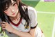 Anime girl in a soccer uniform posing for a picture.