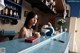 A woman sitting at a counter in a kitchen.