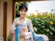 A woman in a colorful dress posing for a picture.