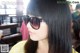 A woman with long black hair wearing sunglasses.