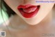 A close up of a woman's lips with red lipstick.